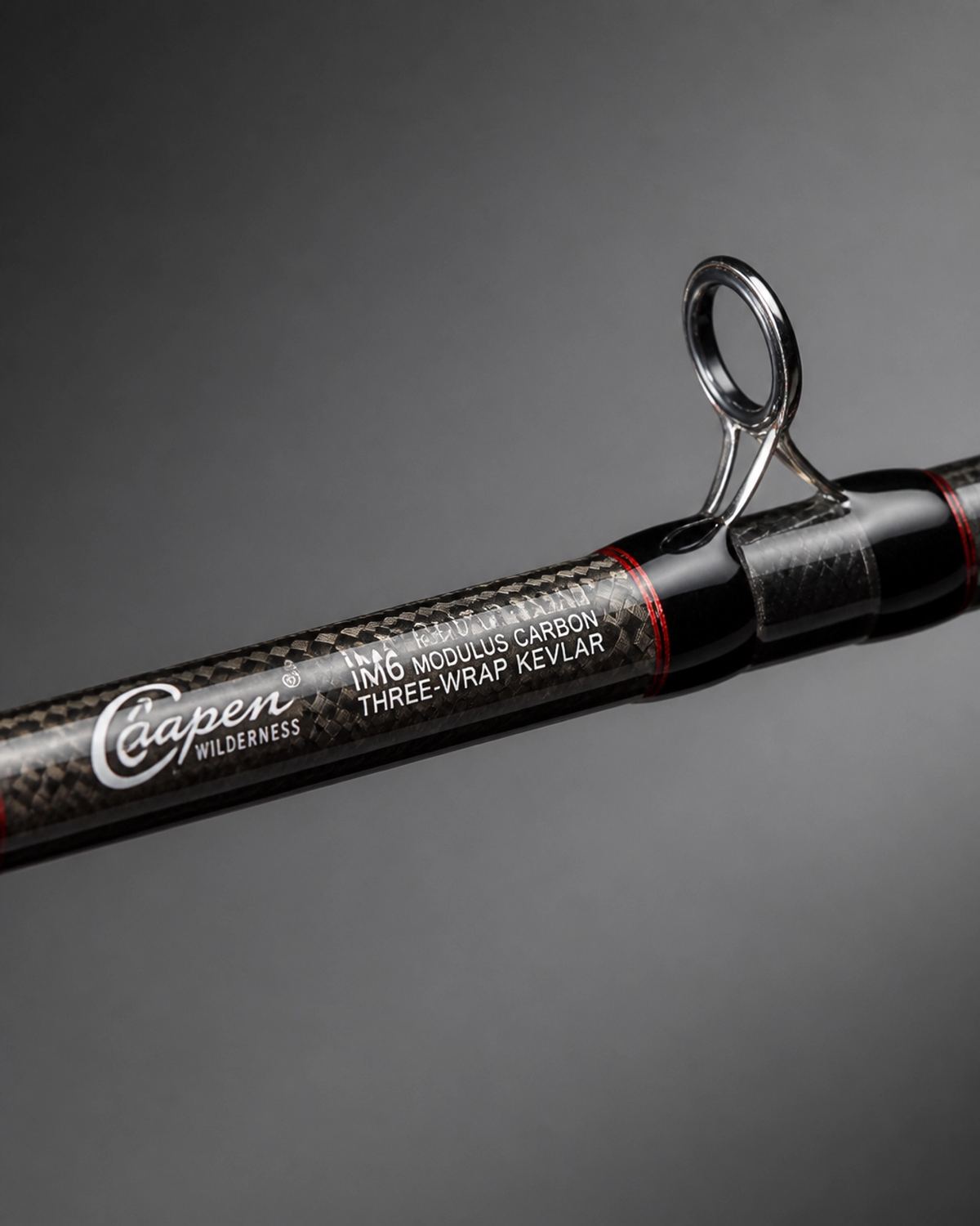 Macro detail of Gapen Wilderness rod blank showing the three-wrap Kevlar reinforcement and IM6 carbon weave