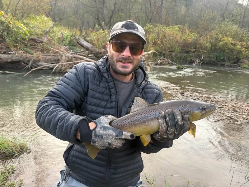Angler holding a brown trout caught on a Gapen Wilderness 5 ft 6 in spinning rod